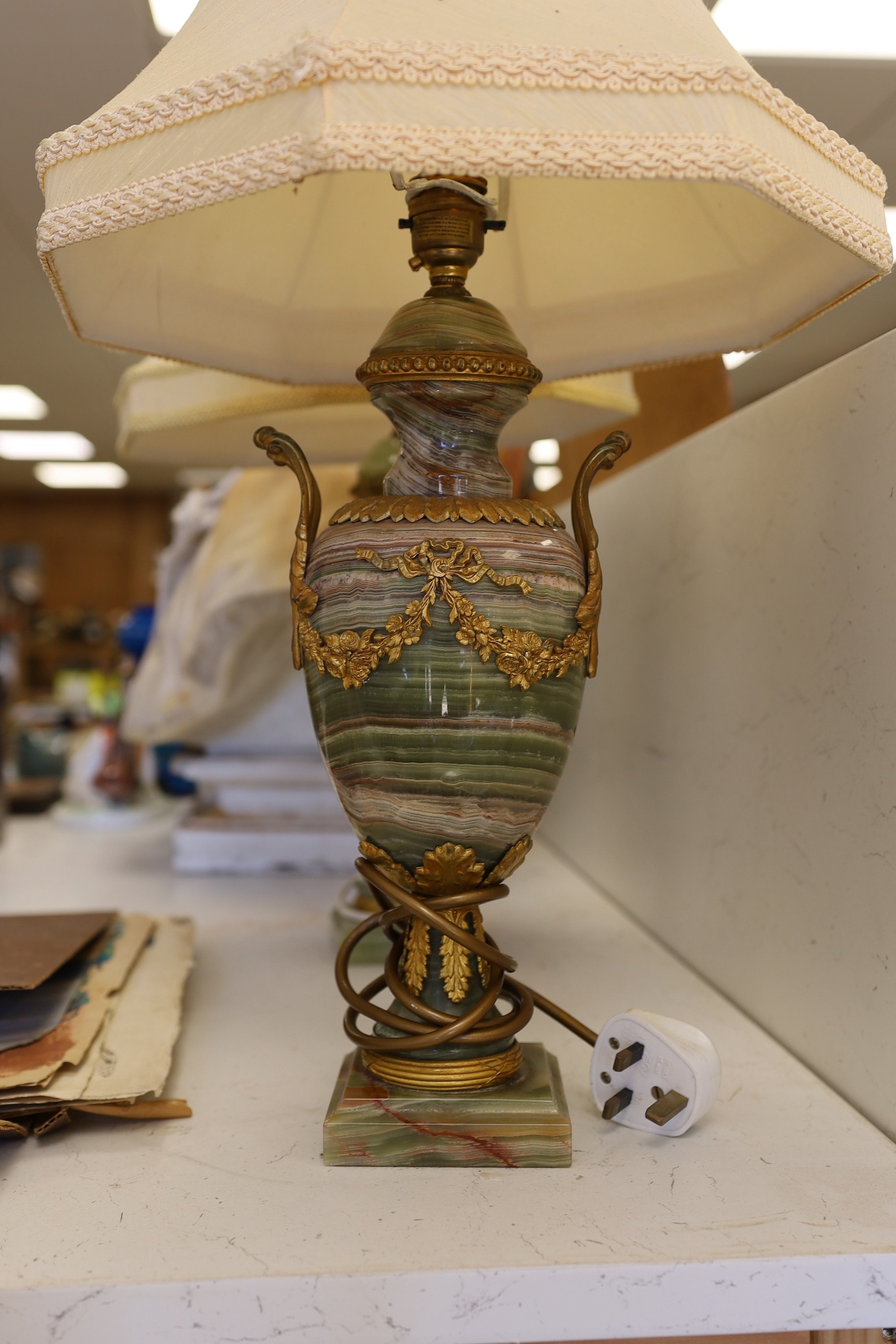 A pair of early 20th century brass mounted onyx urn shaped lamps, 35cm high not including light fitting or shade